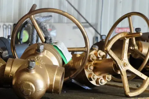Brass safety and master valves racked in the shop